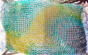 Recycled Plastic Bottles Partially Filled with Colored Water Used to Create a Parking Canopy Recycled Plastic Bottles Partially Filled with Colored Water Used to Create a Parking Canopy